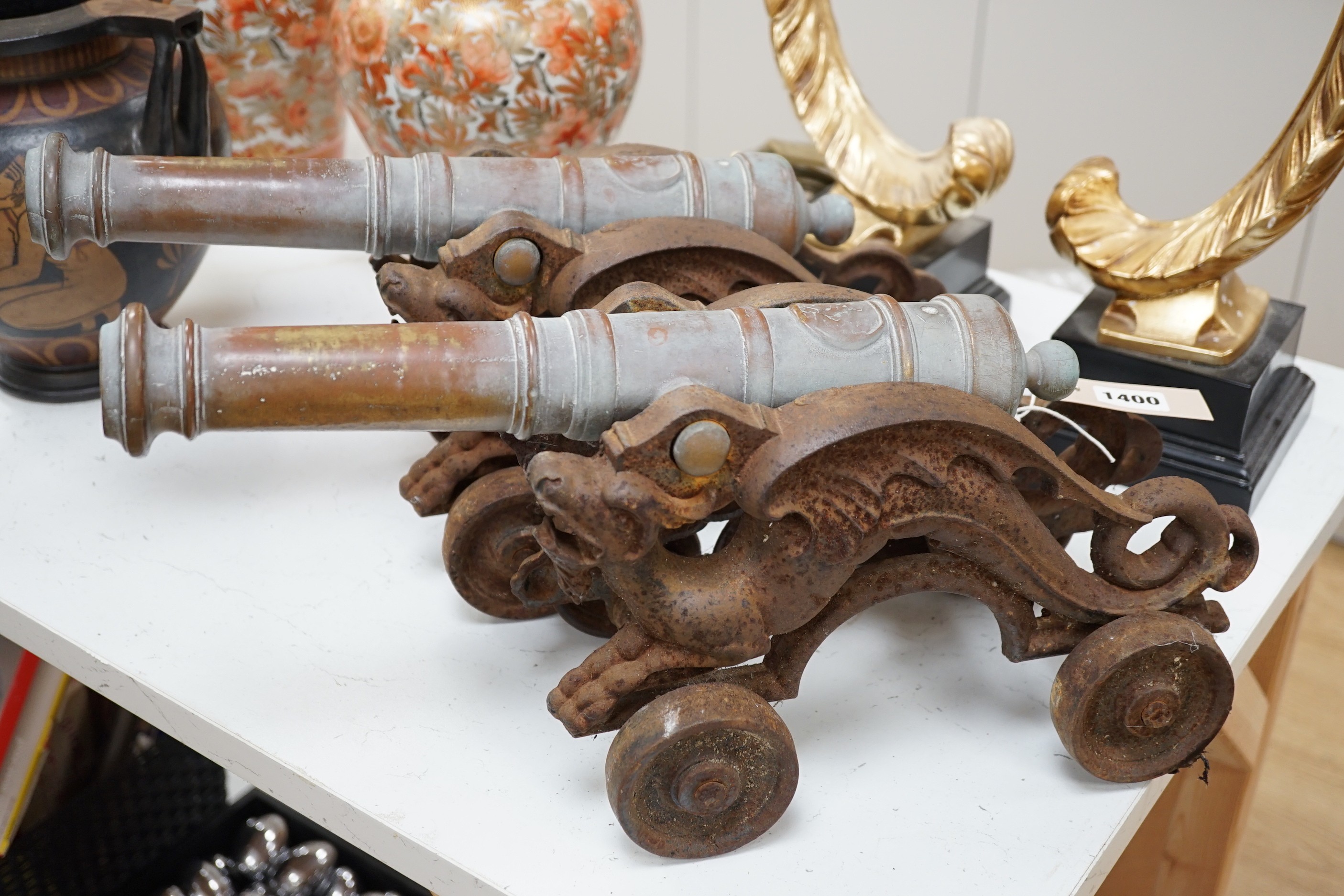 A pair of brass and cast iron model cannons. 45cm wide